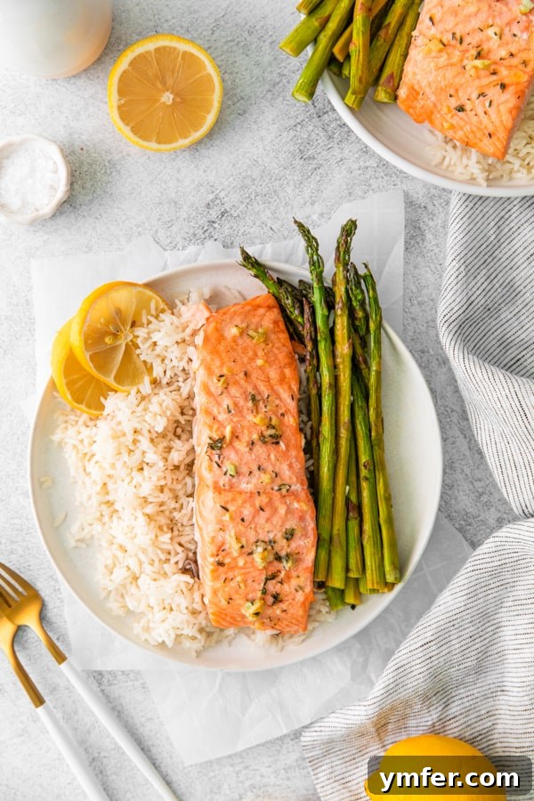Zesty Lemon Salmon Sheet Pan Dinner 2 Sheet Pan Lemon Salmon on a white plate.