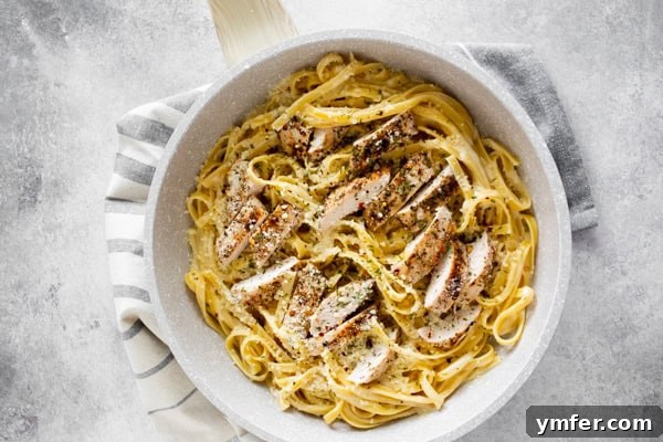 Ultimate Chicken Fettuccine Alfredo 7 Chicken Fettuccine Alfredo in a skillet.