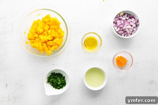 Tropical Inferno Salsa 3 Fresh ingredients for Mango Habanero Salsa laid out on a table, including diced mango, habanero peppers, cilantro, red onion, and lime.