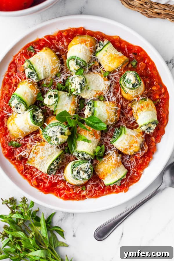 Zucchini Lasagna Rolls on a plate garnished with basil. 