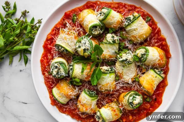 Zucchini Lasagna Rolls on a white round plate. 