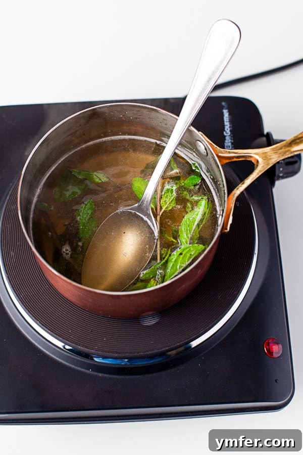 Garden Mint Elixir 5 Cooked Mint Simple Syrup in a pan, ready to be strained.