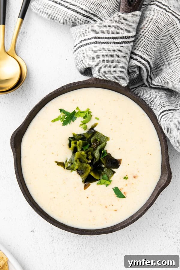Roasted Poblano Cheese Dip 4 Roasted Poblano Queso served in a skillet.