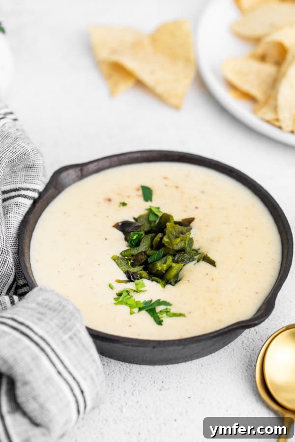 Roasted Poblano Cheese Dip 5 Roasted Poblano Queso in a dish topped with peppers.
