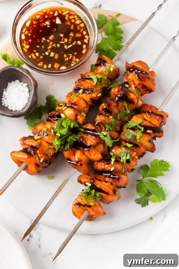 Sweet Heat Chicken Kebabs 2 Hot Honey Chicken Skewers on a white platter.