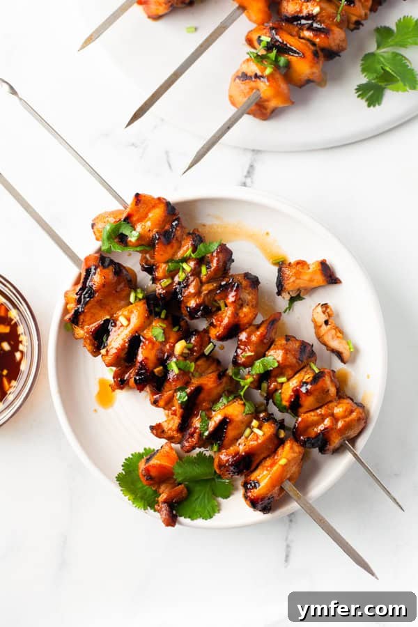 Sweet Heat Chicken Kebabs 5 Hot Honey Chicken Skewers sprinkled with cilantro.