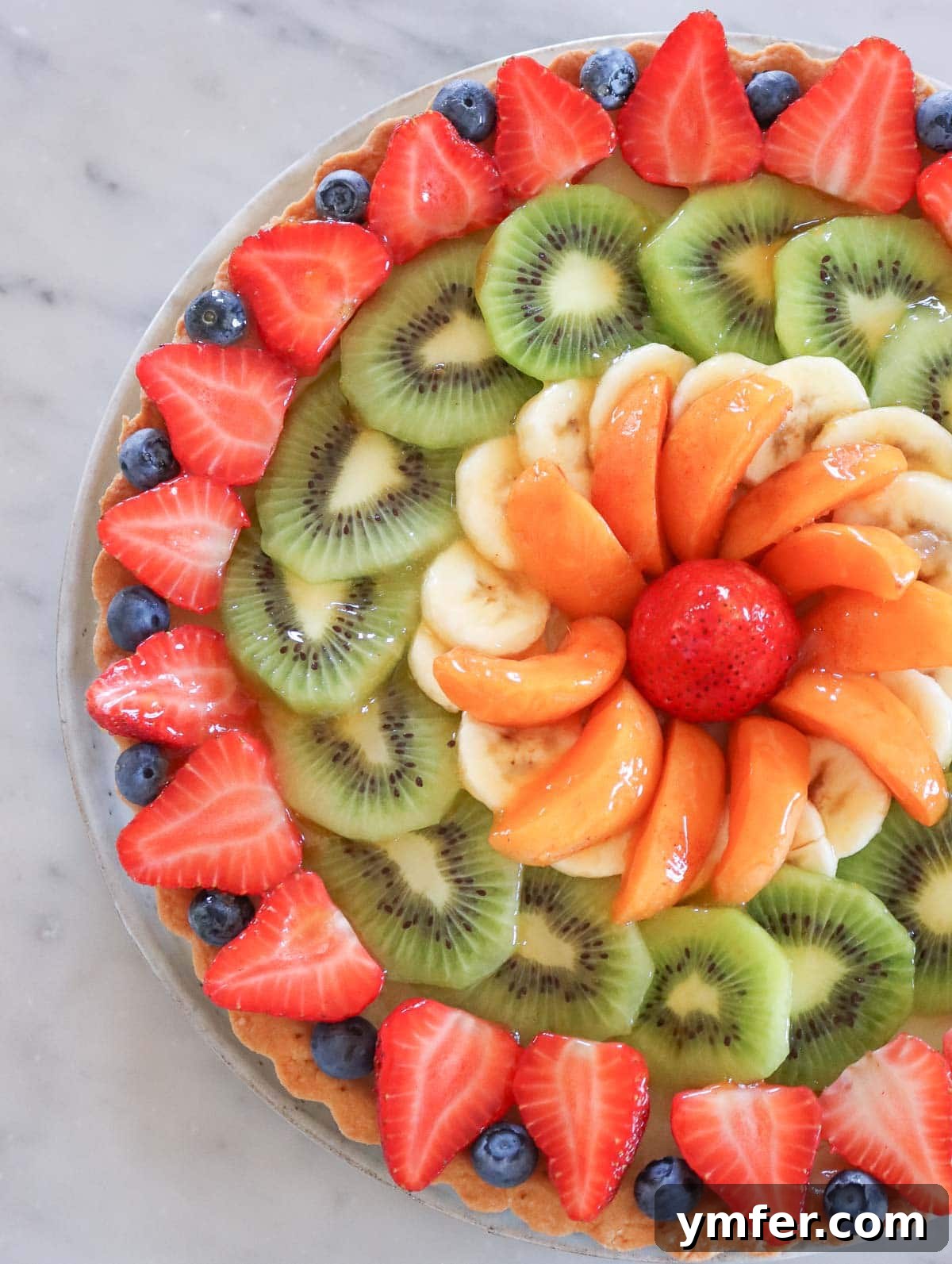 Rainbow Fruit Pizza 15 A delicious vegan fruit tart with a pastry crust and an assortment of fresh fruits, showcasing a beautiful dessert variation.