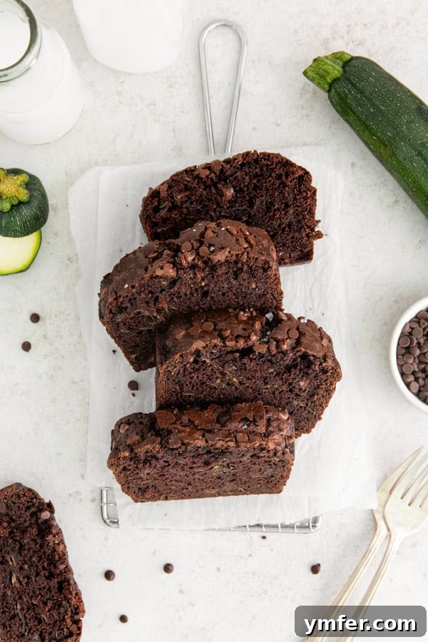 Decadent Chocolate Zucchini Bread 2 Chocolate Zucchini Bread sliced on a table.