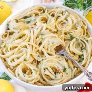 Effortless Lemon Pasta (Creamless) 7 Lemon pasta without cream served in a white bowl, styled with fresh lemons, parsley, and a drizzle of olive oil—light and fresh Italian dinner idea.