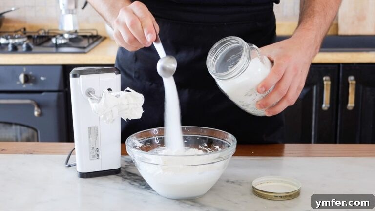 adding sugar to the whipped cream