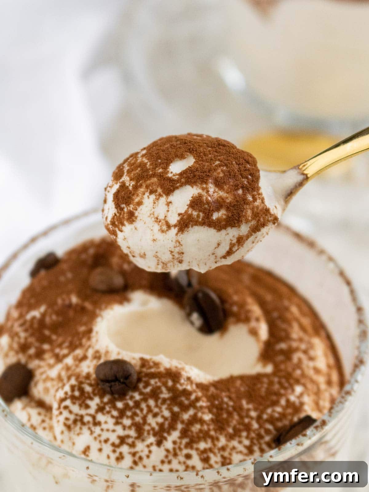 Espresso Cloud 5 spoon eating through a glass with coffee mousse