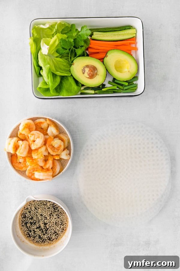 Refreshing Shrimp Garden Rolls 3 Assorted fresh ingredients for Shrimp Summer Rolls laid out on a clean surface, including shrimp, vibrant vegetables like carrots and cucumbers, avocado, herbs, and rice paper wrappers.