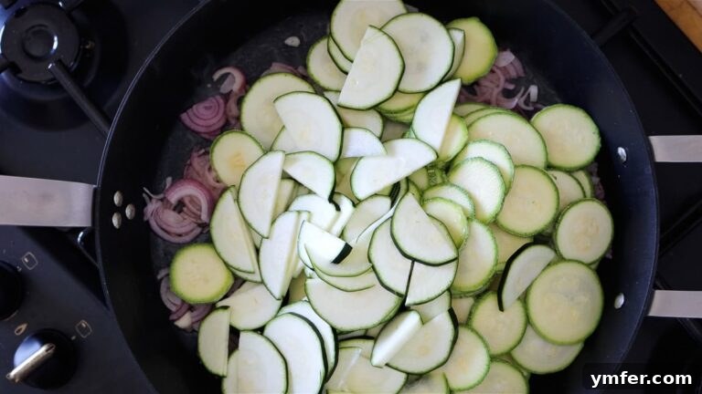 Wholesome Vegan Zucchini Pie 19 Cooking zucchini and onions in a pan