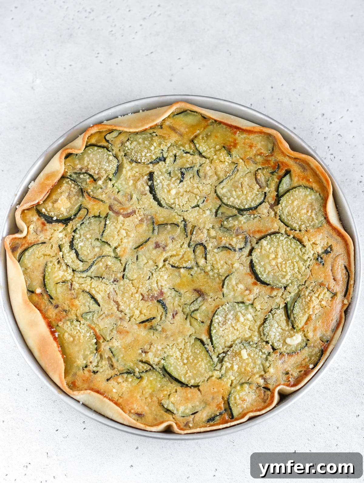 Wholesome Vegan Zucchini Pie 4 Close-up of a zucchini and onion pie slice showing the texture