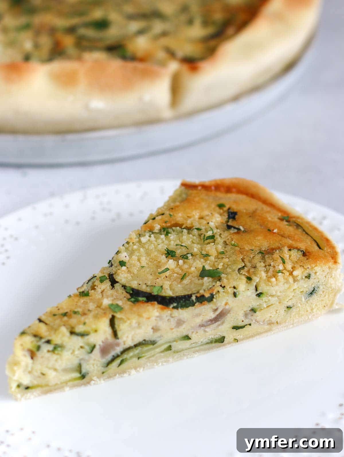 Wholesome Vegan Zucchini Pie 5 A perfectly baked slice of vegan zucchini pie, showing the flaky crust and moist filling