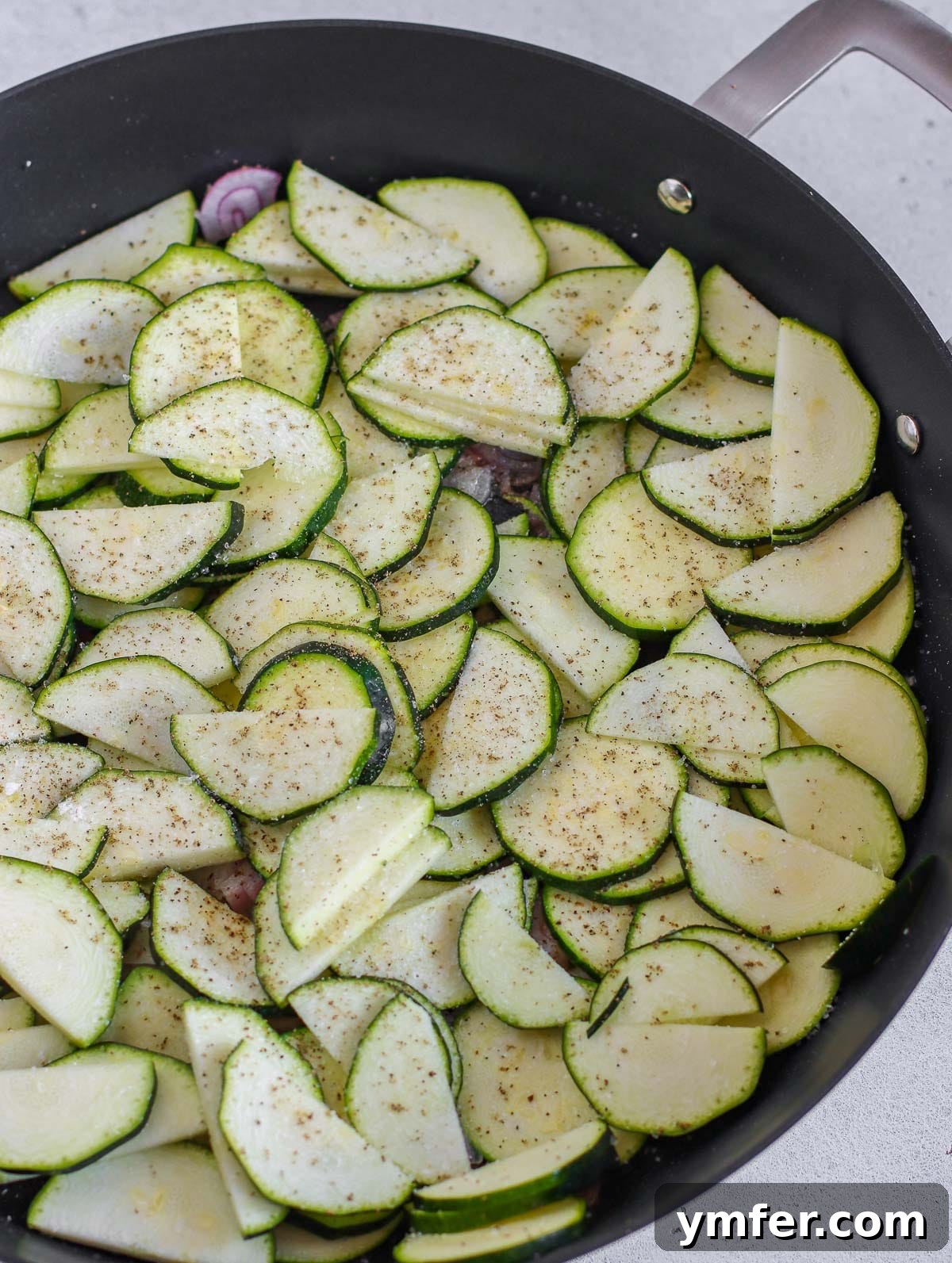 Wholesome Vegan Zucchini Pie 8 Frying zucchini with red onions in a pan