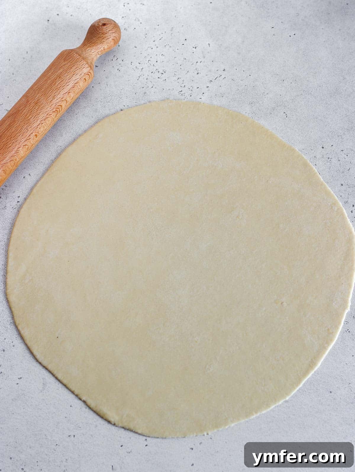 Wholesome Vegan Zucchini Pie 10 Rolling out the pie dough with a rolling pin