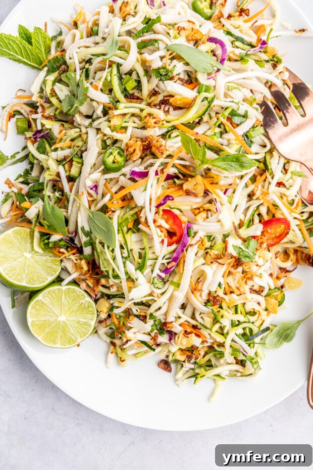 Zesty Vietnamese Zoodle Bowl 2 Vietnamese Zoodle Noodle Salad on a white plate, showcasing its vibrant colors and fresh ingredients.