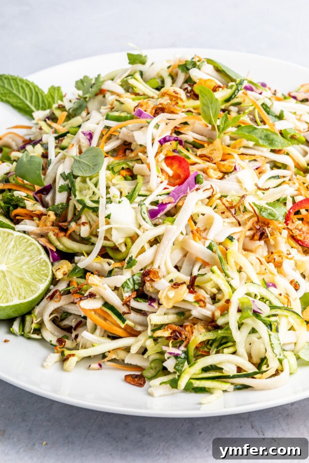 Zesty Vietnamese Zoodle Bowl 6 Vietnamese Zoodle Noodle Salad generously topped with fresh herbs, ready to be enjoyed.