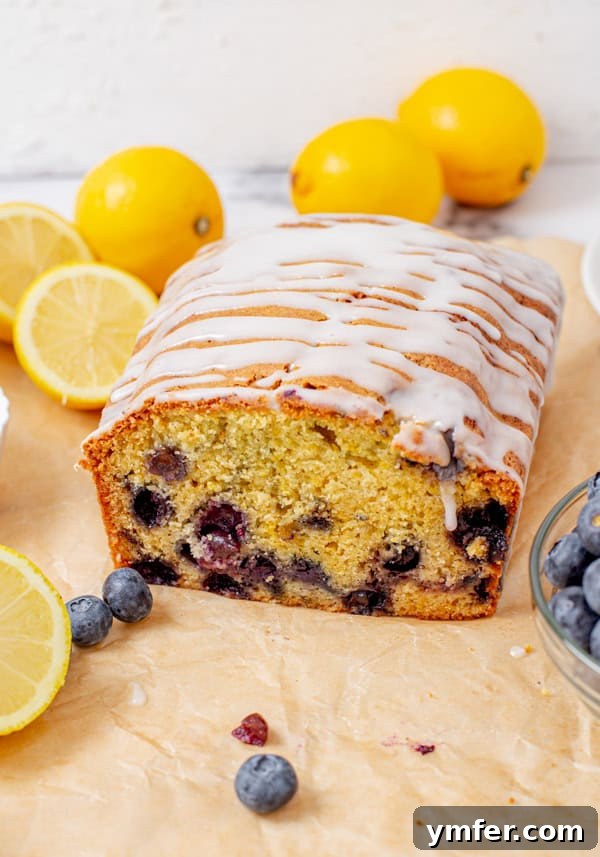 Bursting Blueberry Lemon Loaf 6 Blueberry Lemon Pound Cake on parchment paper.