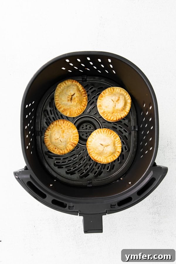 Crispy Air Fryer Apple Hand Pies 4 Apple hand pies in the air fryer.