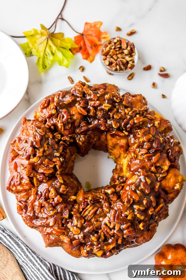 Pumpkin Monkey Bread with a rich caramel glaze and chopped pecans, perfect for fall.