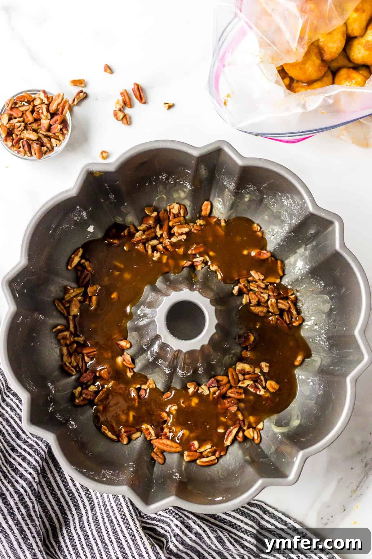Biscuit dough half folded over, enclosing the pumpkin puree to form a ball.