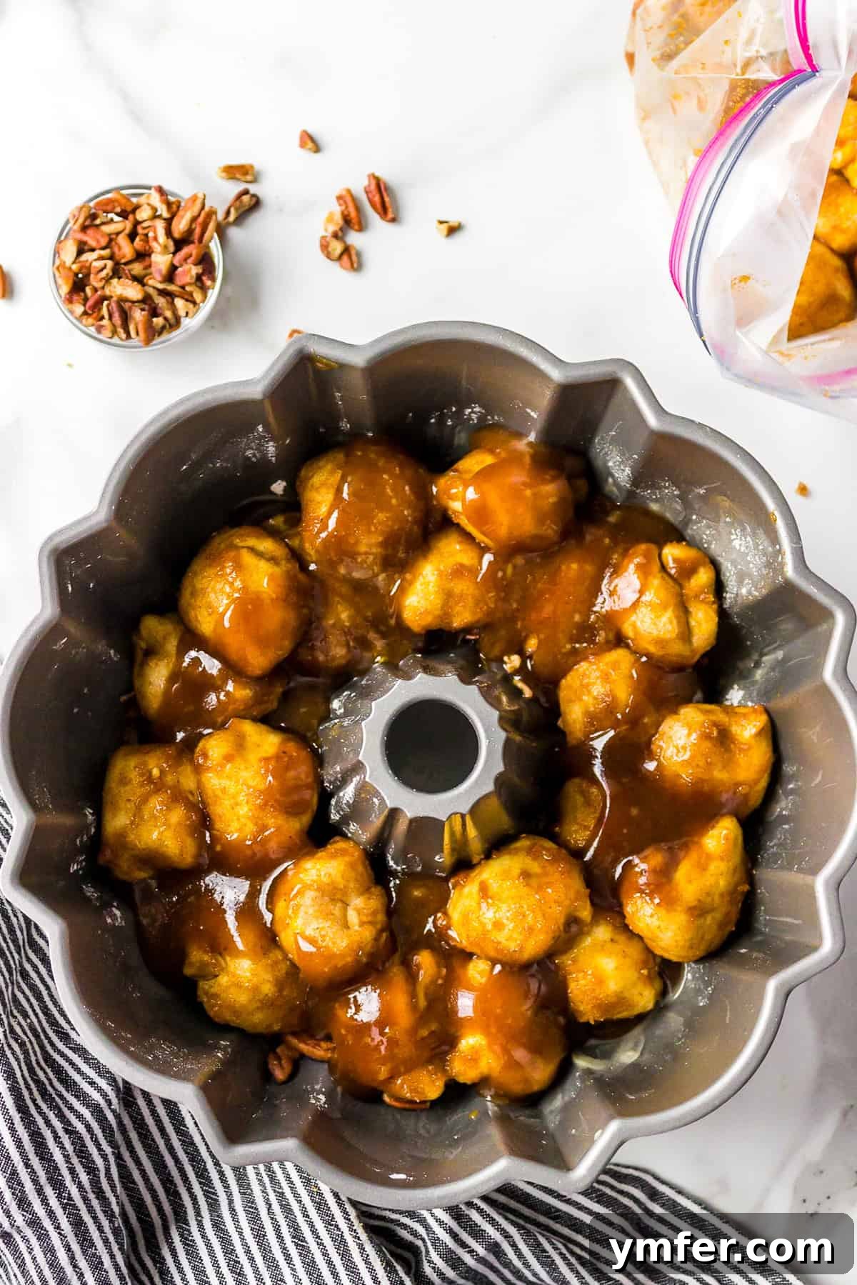 Biscuit dough balls coated in sugar and spice mixture in a ziploc bag.