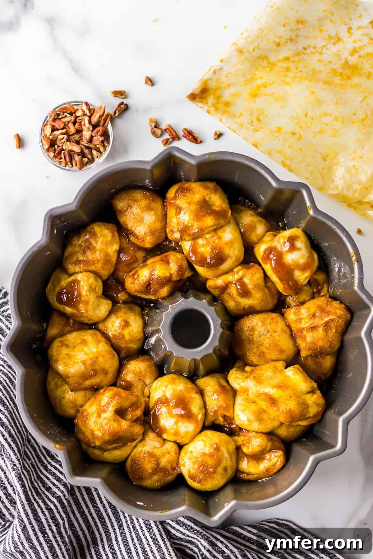 Pecan nuts and caramel sauce poured into the bottom of a bundt pan.