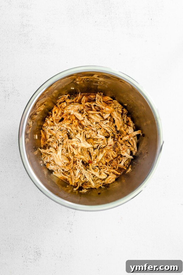 Effortless Instant Pot Chicken Tacos 5 Perfectly shredded chicken resting in the Instant Pot after cooking, ready for serving.