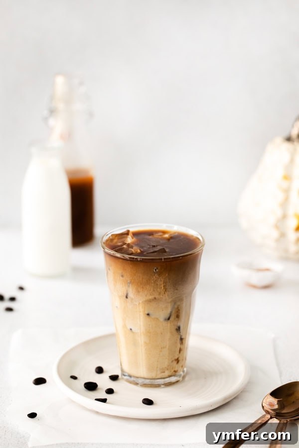 Iced Pumpkin Chai Latte served in a glass. 