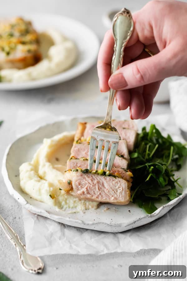 Perfect Air Fryer Pork Chops 5 A fork picking up a slice of air fryer pork chop.