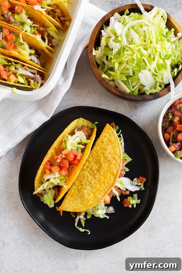 Crispy Baked Beef Tacos 2 A dish filled with perfectly baked ground beef tacos, some already plated and ready to enjoy.