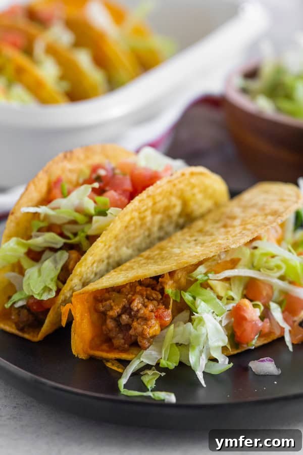 Crispy Baked Beef Tacos 5 A perfectly plated baked ground beef taco, garnished with fresh toppings and ready to be enjoyed.