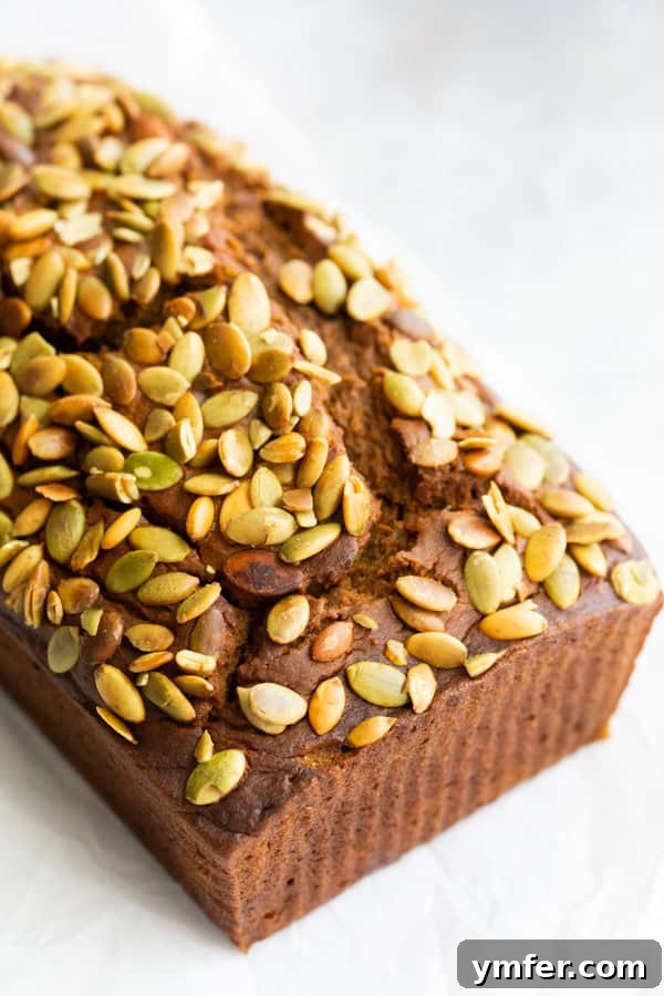 Copycat Starbucks Pumpkin Bread topped with pumpkin seeds. 