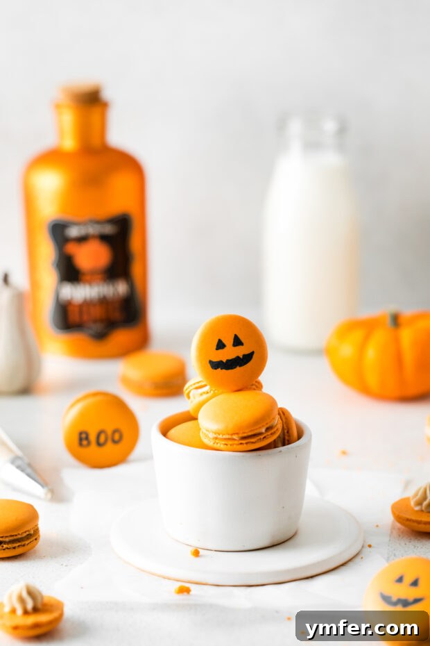 Seasonal Pumpkin Spice Macarons 2 Festive Pumpkin Spice Macarons artfully decorated to resemble carved pumpkins, showcasing their vibrant color and delicate texture.