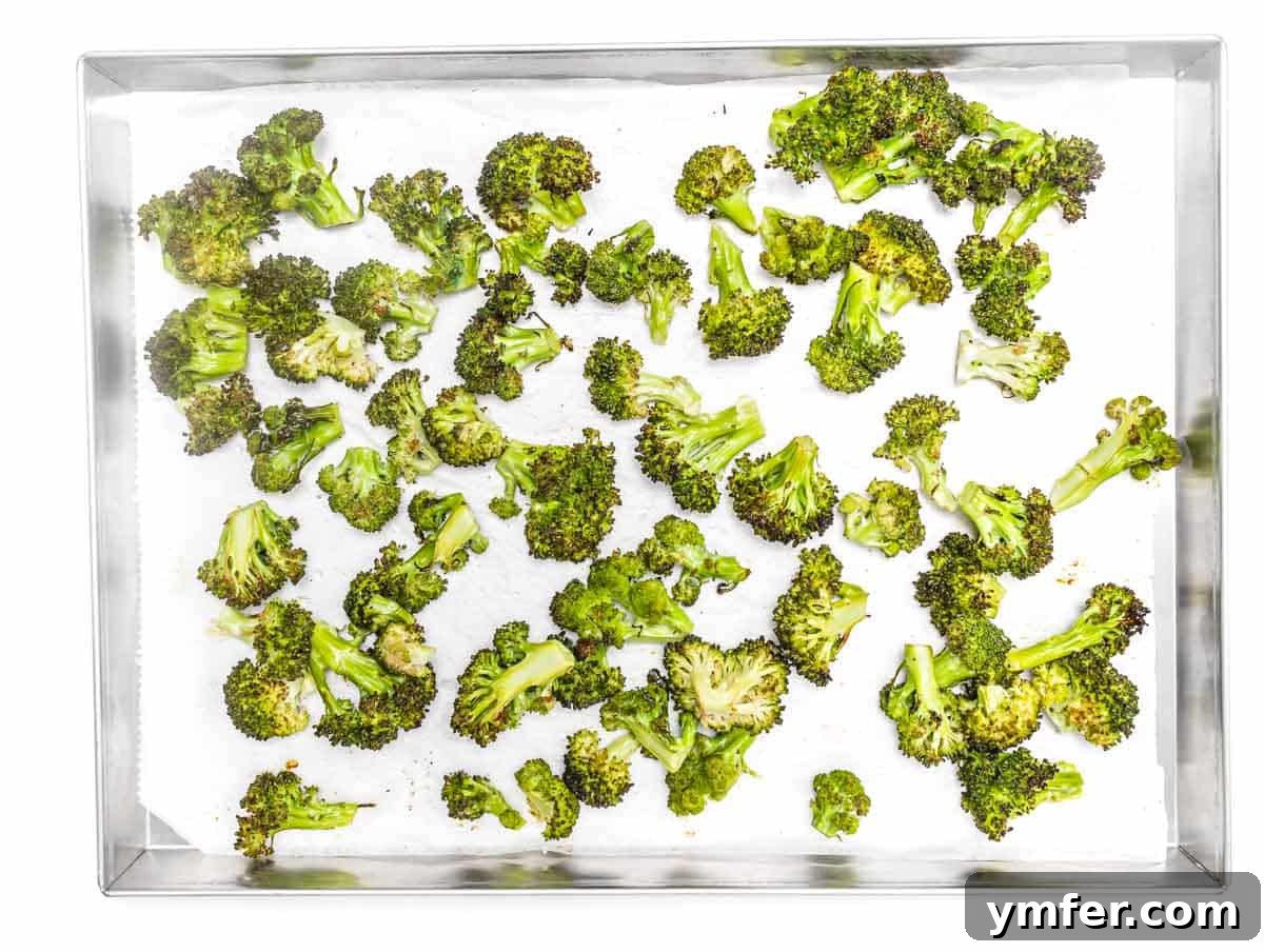 Baked broccoli florets in a silver tray, golden and tender-crisp