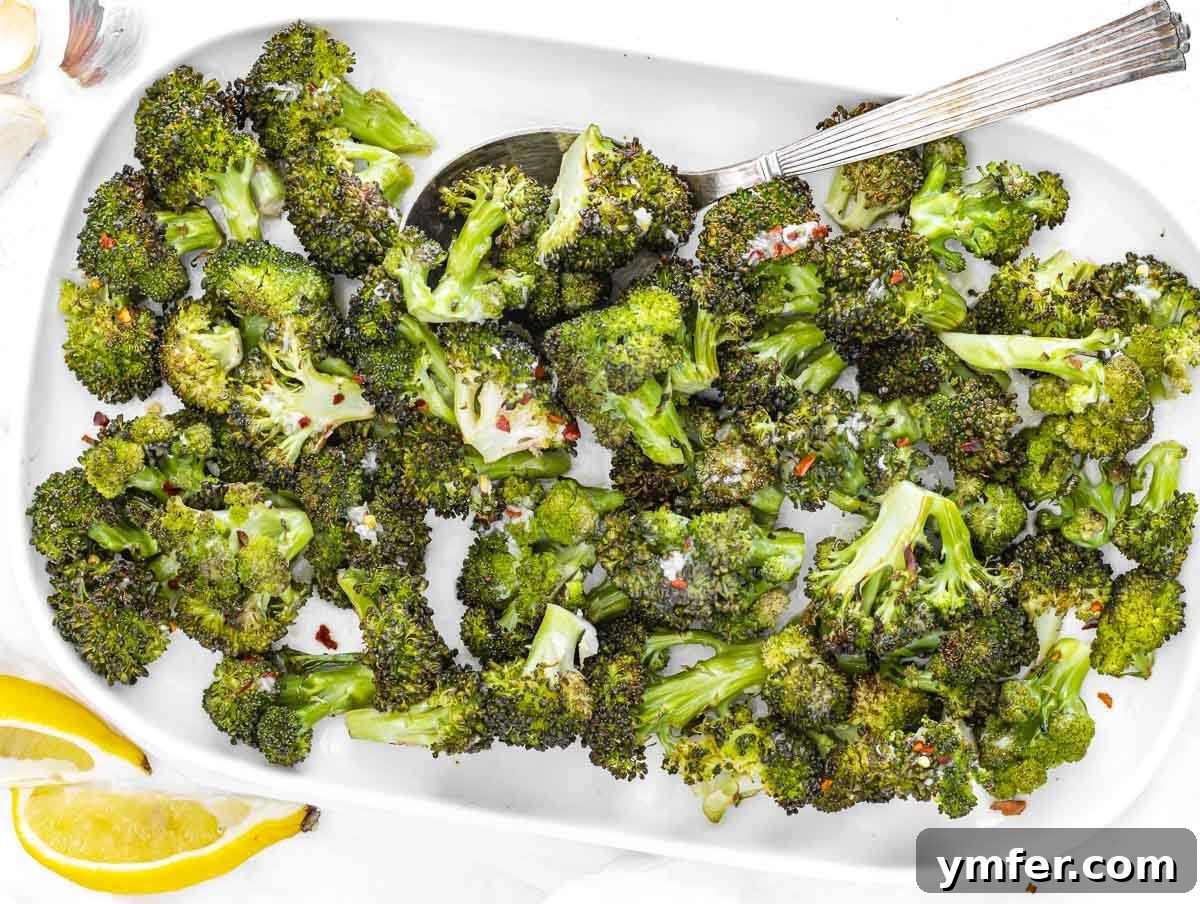 Baked broccoli served on a platter, drizzled with dressing
