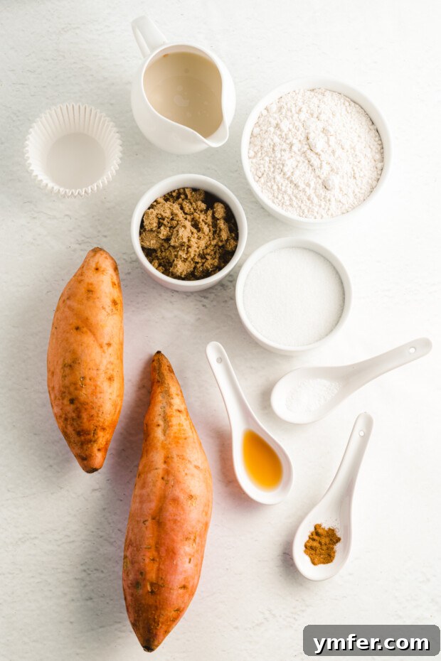 Spiced Sweet Potato Muffins 3 Assortment of fresh ingredients for baking sweet potato muffins laid out on a counter.