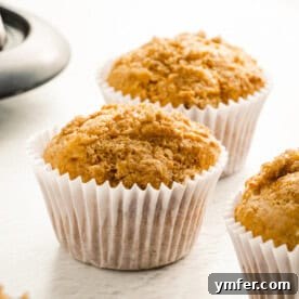 Appetizing sweet potato muffin in a paper liner, featured in recipe card.
