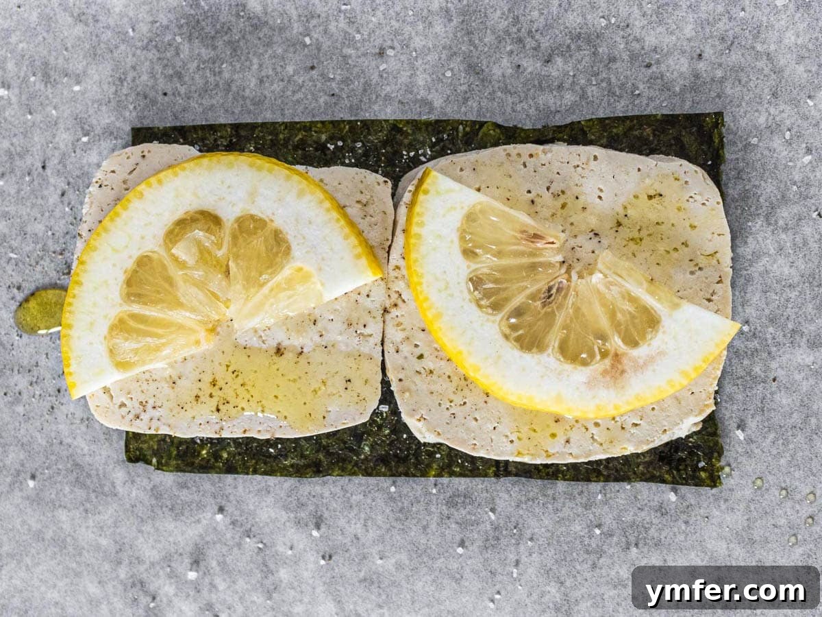 The Vegan Catch 10 tofu slices on nori sheet with lemon slices