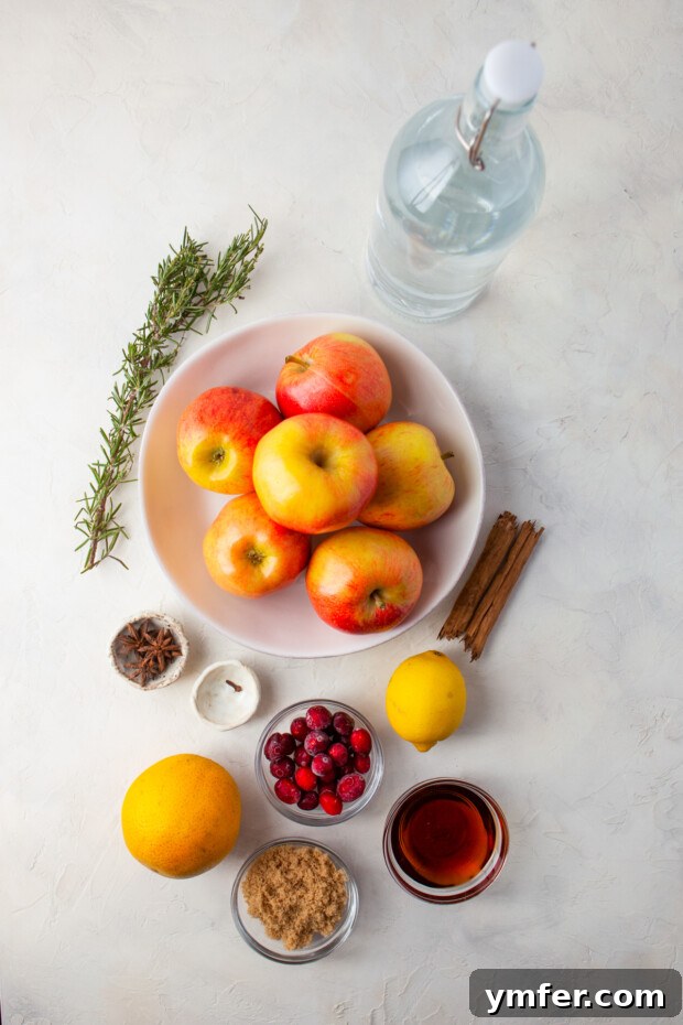 Instant Pot Spiced Apple Cider 3 Fresh ingredients for Instant Pot Apple Cider laid out on a wooden table.