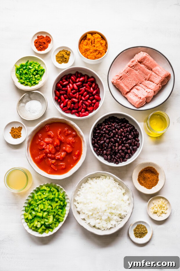 Autumn Harvest Turkey Chili 3 A vibrant display of fresh ingredients, including ground turkey, bell peppers, onions, canned tomatoes, and spices, meticulously arranged on a rustic wooden table, ready to be transformed into Turkey Pumpkin Chili.