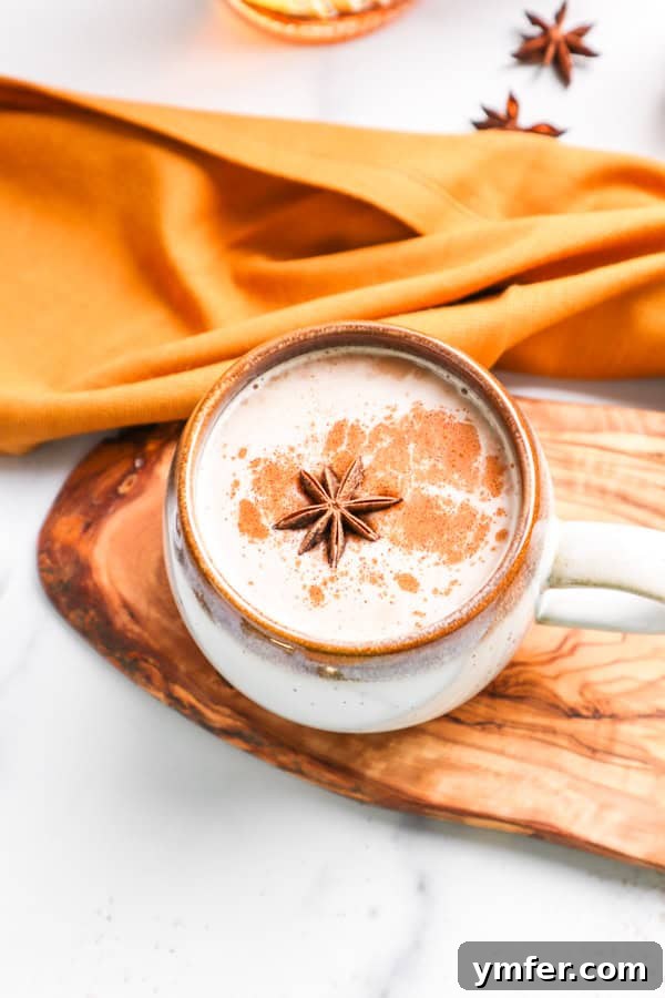 A Skrewball Chai Tea Latte garnished with a beautiful star anise pod and a sprinkle of cinnamon, ready for enjoyment.