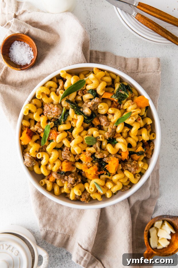 Autumn Butternut Squash Sausage Pasta 2 A hearty bowl of Butternut Squash Sausage Pasta, garnished with fresh herbs, ready to be enjoyed.