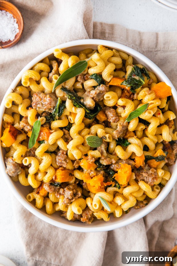 Autumn Butternut Squash Sausage Pasta 8 Butternut Squash Sausage Pasta served in a bowl, garnished with fresh sage leaves.