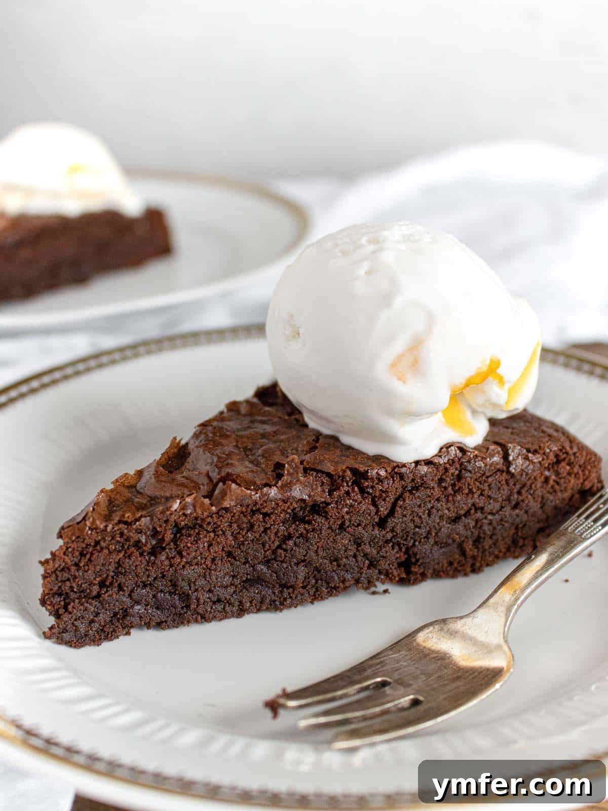 Decadent Chocolate Brownie Cake 2 Decadent fallen vegan chocolate brownie cake served on a plate, rich and fudgy texture visible
