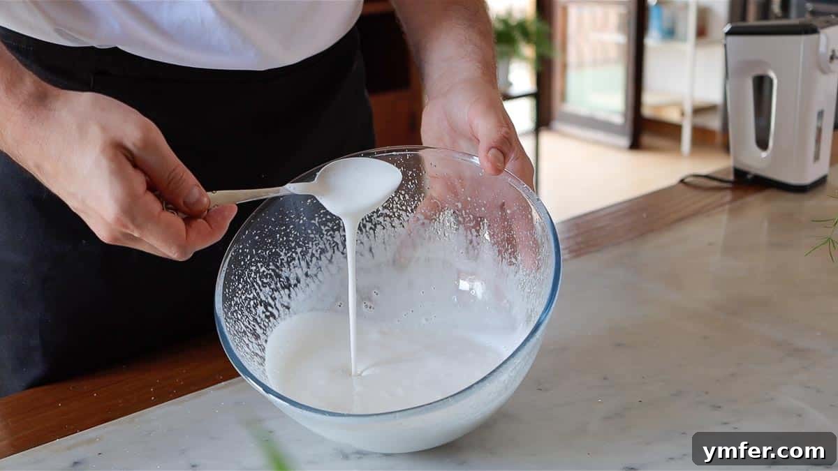 Decadent Chocolate Brownie Cake 11 Close-up of the fully whipped, foamy, thick liquid mixture of sugar and aquafaba