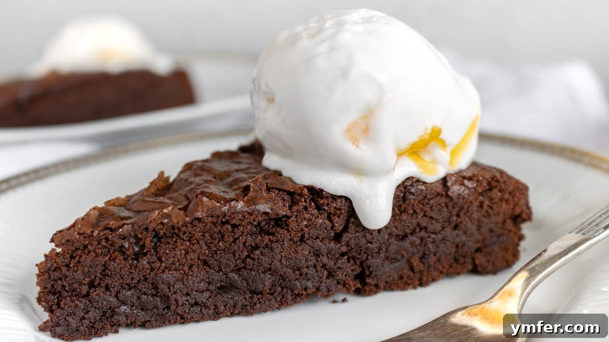 Decadent Chocolate Brownie Cake 18 A beautiful, freshly baked vegan chocolate brownie cake on a serving dish, ready to be enjoyed