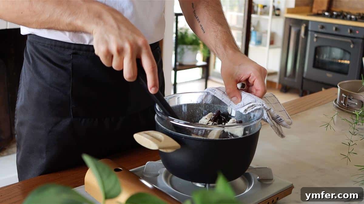 Decadent Chocolate Brownie Cake 7 Stirring melting chocolate and butter in a double boiler until smooth and well combined